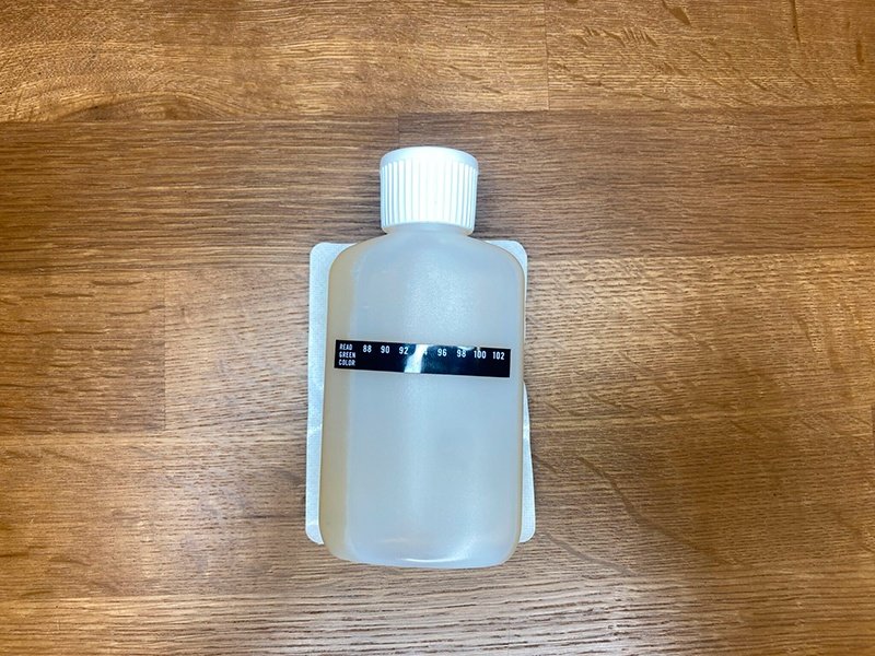 synthetic urine bottle with attached heat pad